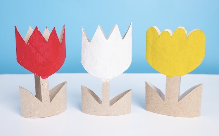 How to cut flower shapes out of a toilet paper roll tube to make colorful spring time flowers.