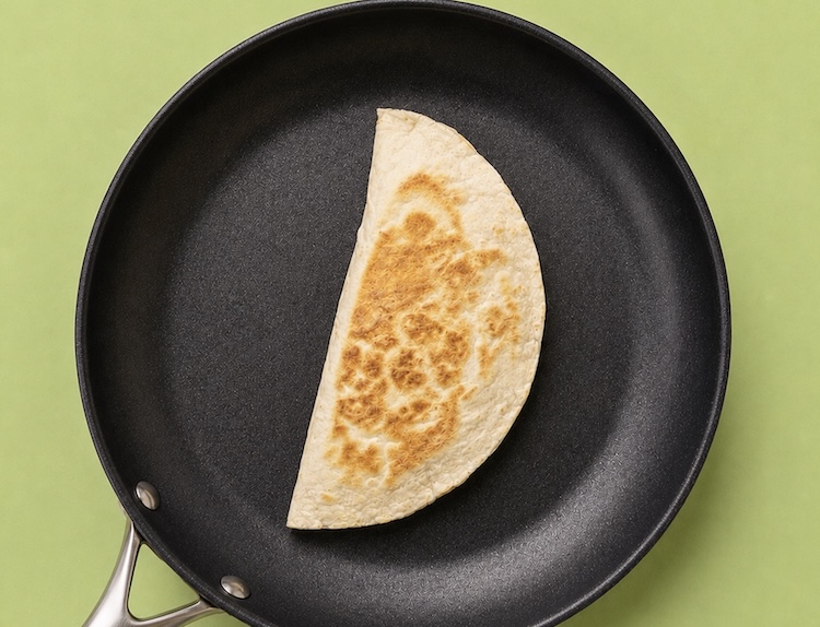 peanut butter quesadilla cooking in a pan.
