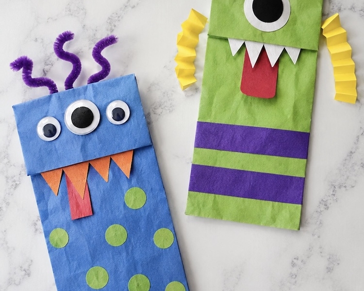 Monster craft ideas for Halloween | DIY craft tutorial on how to make scary yet cute monsters with brown paper lunch bags and construction paper.
