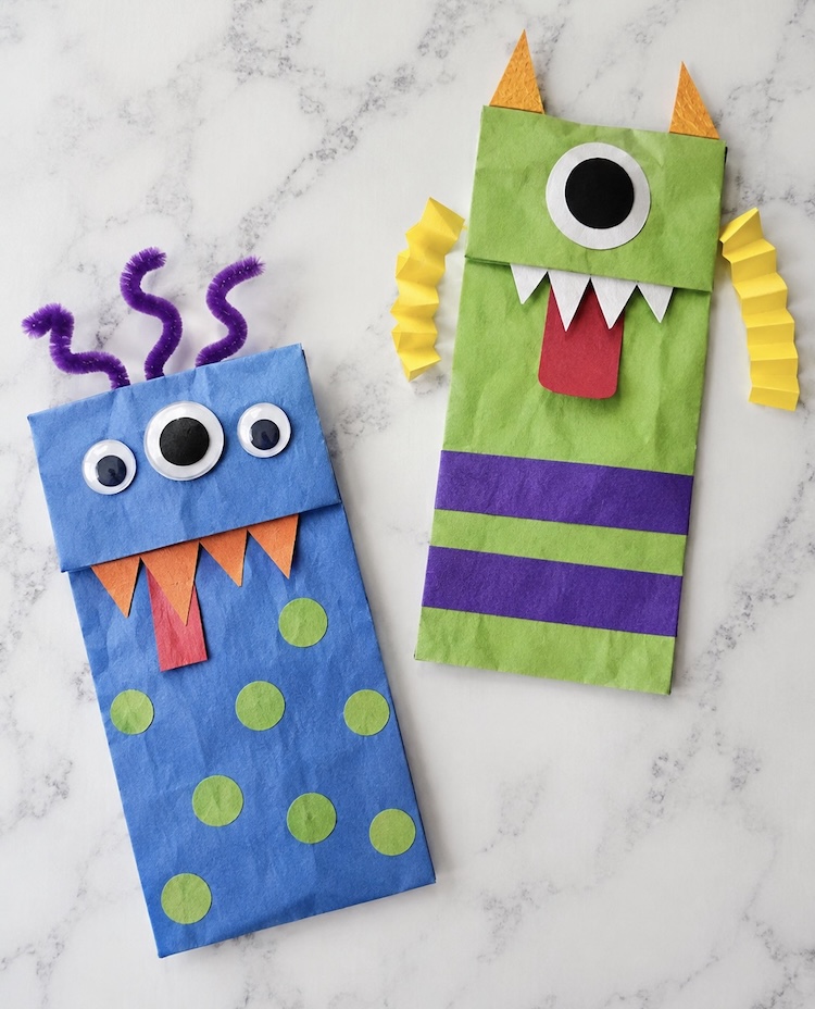 Monster craft ideas for Halloween | DIY craft tutorial on how to make scary yet cute monsters with brown paper lunch bags and construction paper.