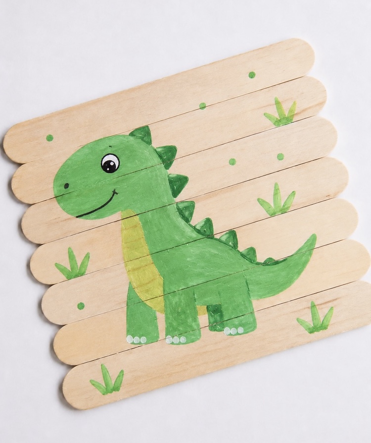 Popsicle stick puzzle with a dinosaur painting. 
