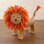 This adorable lion craft for kids is easy to make with cheap recycled toilet paper roll tubes and colorful yarn to make the impressive mane! It's a simple zoo animal craft for preschoolers and older kids. Full step by step tutorial included with lots of photos.