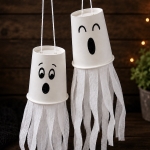 How to make paper cup flying ghosts for halloween with a step by step tutorial and photos. A fun fall craft for kids to make! Easy, cheap, and low mess.