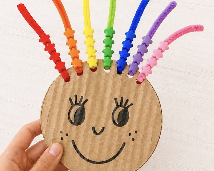 DIY Rainbow Hair Bead Activity to help toddlers and young kids with color recognition and fine motor skills while having fun!