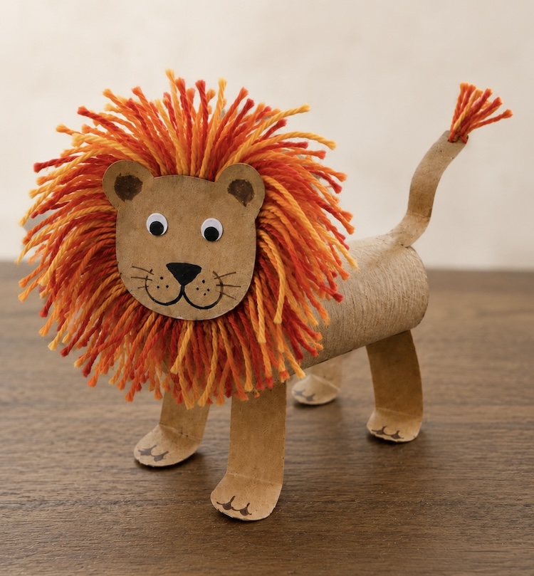 DIY Craft Tutorial: How to make adorable toilet paper roll lions with a fuzzy yarn mane and googly eyes. A fun animal craft for kids of all ages! So simple and yet impressive.