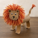 DIY Craft Tutorial: How to make adorable toilet paper roll lions with a fuzzy yarn mane and googly eyes. A fun animal craft for kids of all ages!