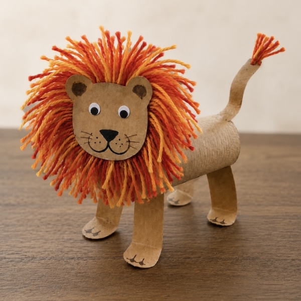 DIY Craft Tutorial: How to make adorable toilet paper roll lions with a fuzzy yarn mane and googly eyes. A fun animal craft for kids of all ages!