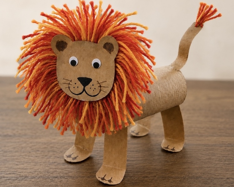 DIY Craft Tutorial: How to make adorable toilet paper roll lions with a fuzzy yarn mane and googly eyes. A fun animal craft for kids of all ages!