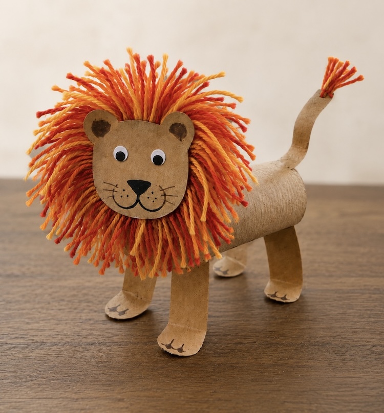 DIY Craft Tutorial: How to make adorable toilet paper roll lions with a fuzzy yarn mane and googly eyes. A fun animal craft for kids of all ages!