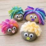 Pet rock ideas for kids with pictures and a fun craft tutorial. These cute fluffy rocks are made with smooth rocks, yarn, felt, and googly eyes.