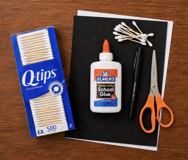 Q tips, glue, and paper supplies ready to make a unique and creative skeleton for Halloween. A fun Halloween art project for little kids.