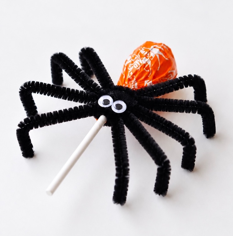 This popular Halloween craft and party treat is a huge hit with kids! Simply wrap a few black pipe cleaners around your favorite lollipops to make candy spiders. They great for fall parties, treat bags, and bringing to school on Halloween.