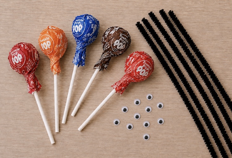 Tootsie pops, black pipe cleaners, and googly eyes.