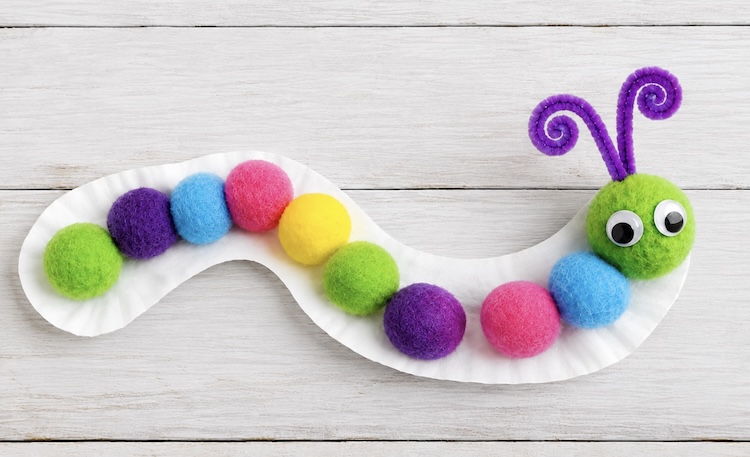 How to make a fun and fuzzy caterpillar craft for kids with a paper plate and pom poms.