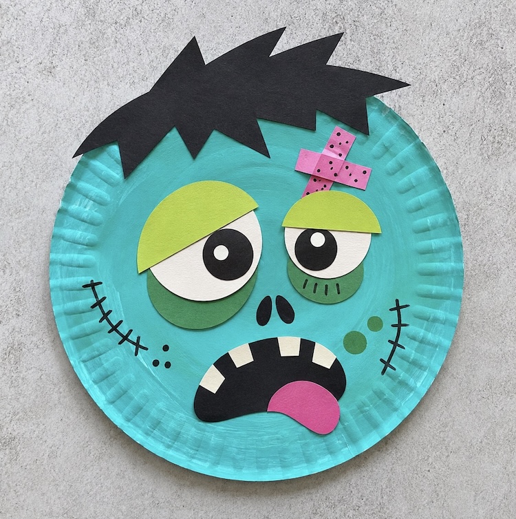 Colorful paper plate zombie craft for a fun Halloween project for kids to make at home. 