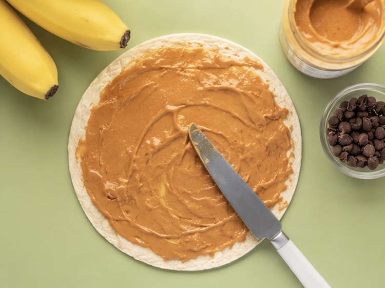 Making peanut butter banana tortilla wraps into breakfast quesadillas.