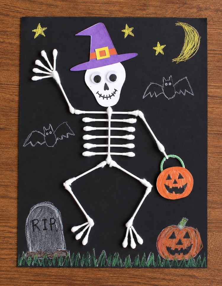 This easy spooky skeleton craft was a huge hit with my kids, as so easy to make with q-tips, black paper, and glue. A fun, cheap art project to make this fall on a rainy day at home.