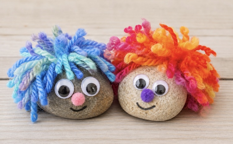 The cutest DIY pet rocks made with yarn hair and googly eyes! A fun easy and cheap craft project for kids.