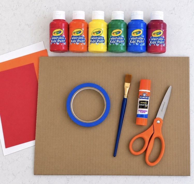 Large piece of scrap cardboard and art supplies needed to make turkey art.