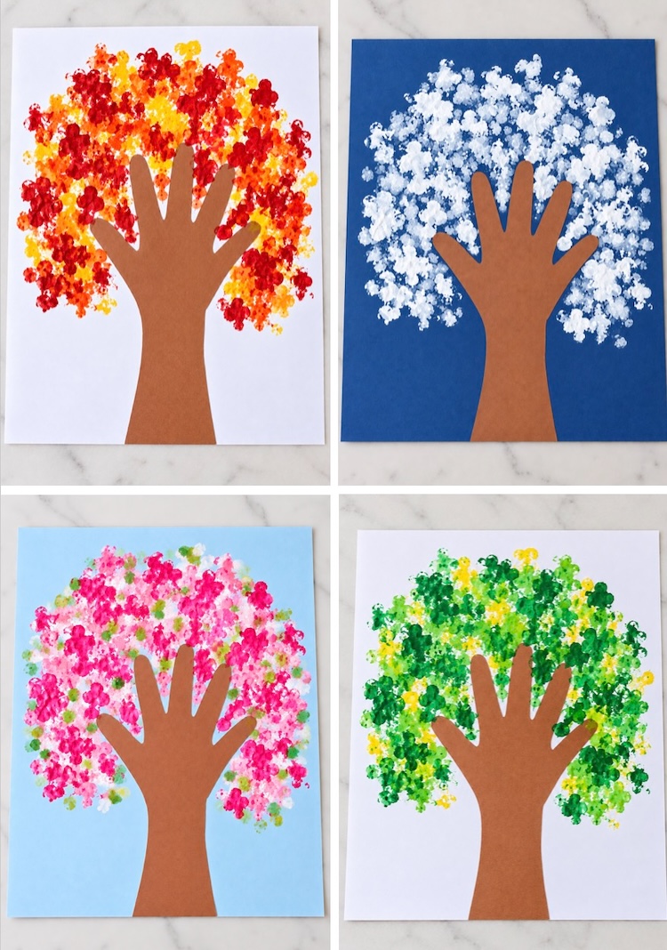 Easy construction paper tree art kids craft using q-tips as paint brushes and a traced hand as the tree trunk. This simple low mess craft is made with cheap supplies and is fun for kids of all ages.