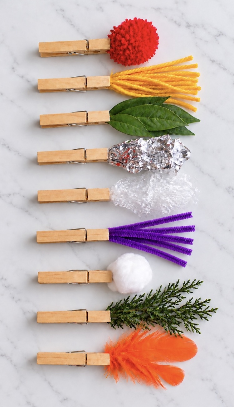 How to make creative paint brushes for kids for making simple art using clothes pins and household items like pom-poms, foil, feathers, leaves, etc.