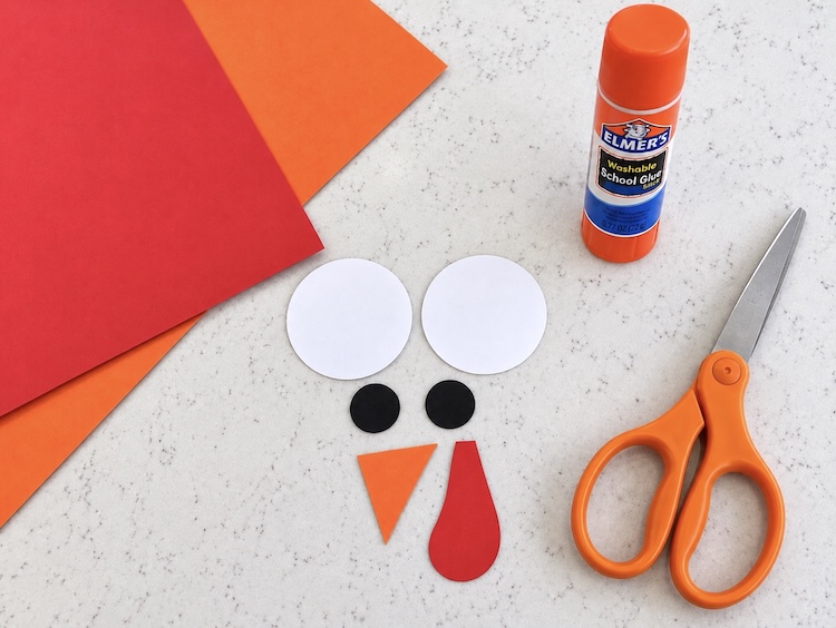 Making a cute turkey face using colorful construction paper. 