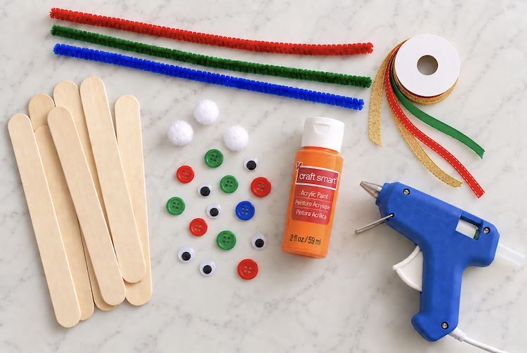 Popsicle sticks, pipe cleaners, googly eyes, ribbons, buttons, pom poms, paint, and a hot glue gun.