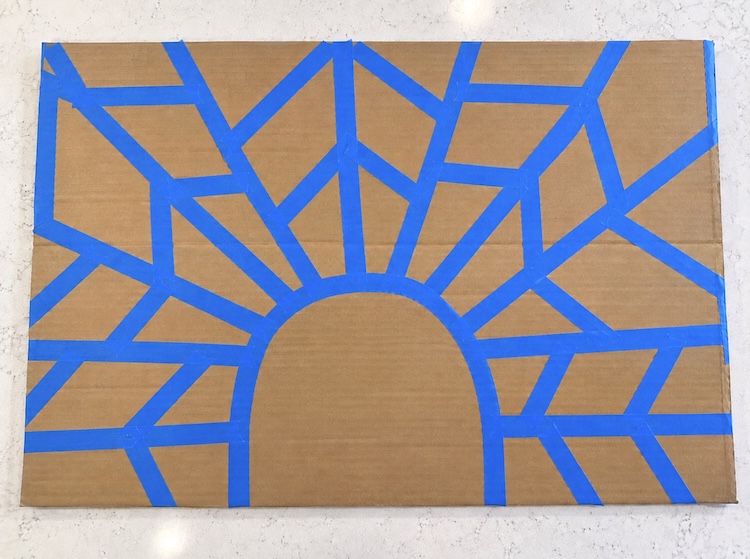 How to make tape resistant turkey art with kids using painters tape and a large piece of cardboard. 