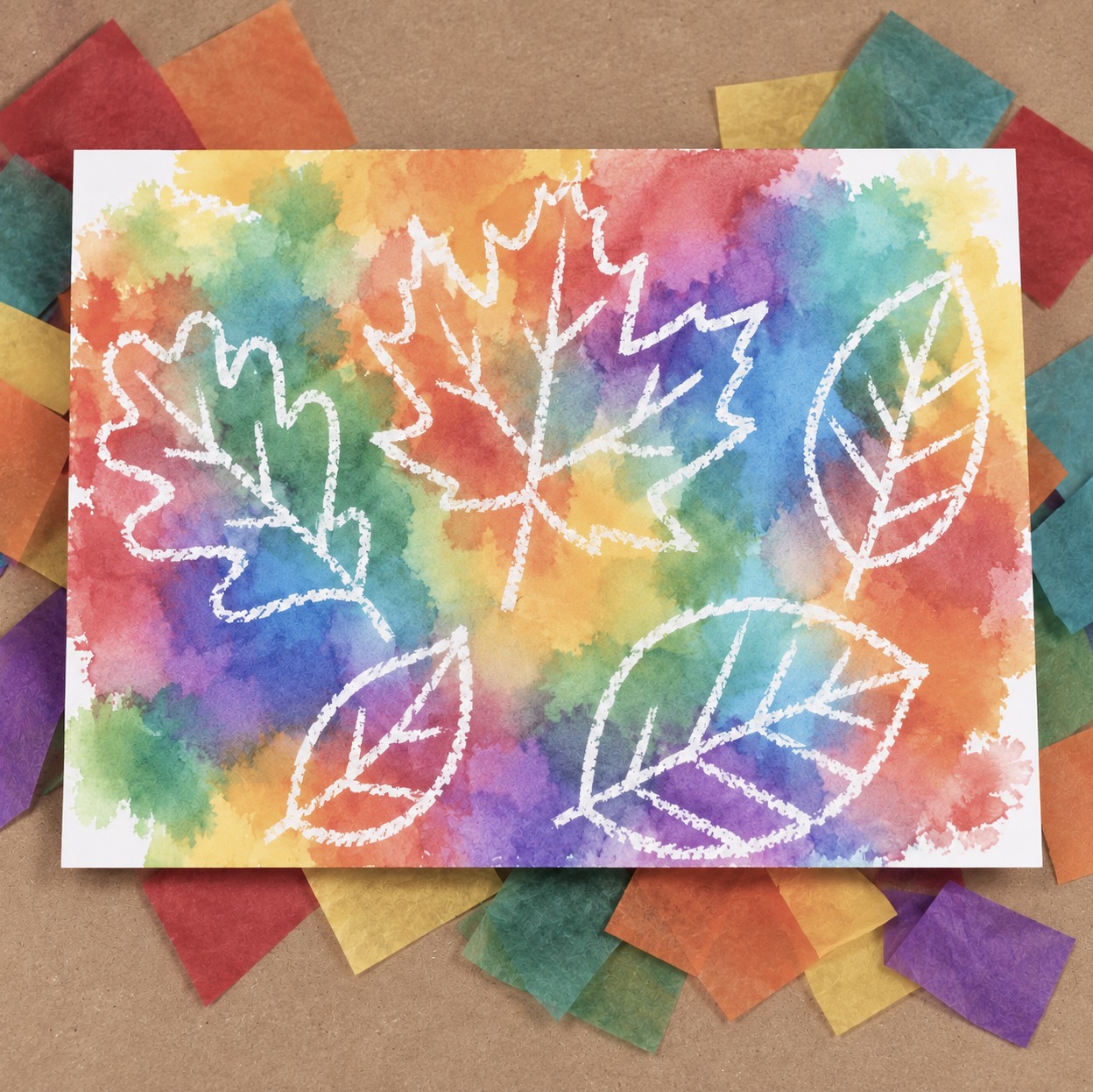 Color transfer art using bleeding tissue paper and white cardstock. An easy craft project for kids to make using a water bottle and white crayon to make leaf or flower designs.