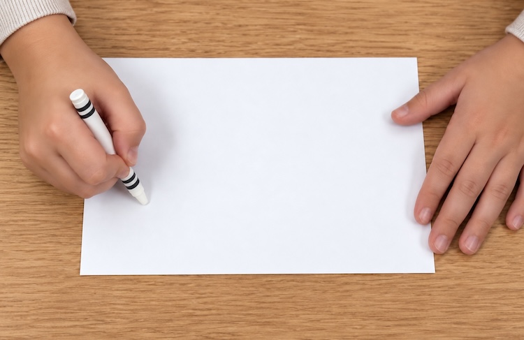 Using a white crayon to draw on white cardstock to create designs that resist color to create fun surprise art once finished.