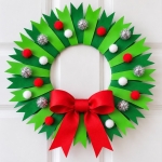 How to make a beautiful paper plate Christmas tree craft with a full tutorial and step by step instructions. A cheap and simple holiday project to make at home with the kids.