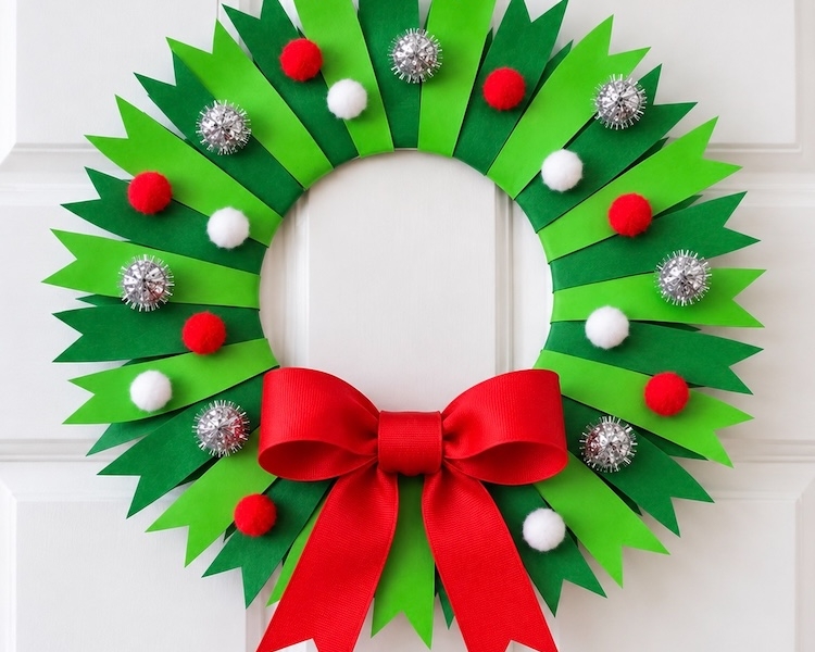 How to make a beautiful paper plate Christmas tree craft with a full tutorial and step by step instructions. A cheap and simple holiday project to make at home with the kids.