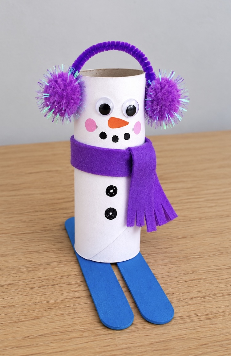 How to make an easy snowman craft for Christmas on popsicle stick skis. A fun and cheap craft for kids to make at home over the holidays!