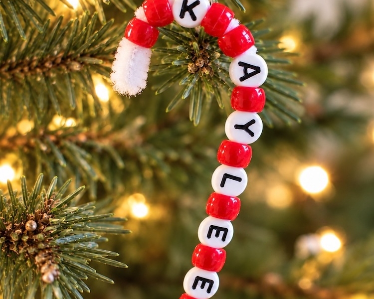 How to make the easiest DIY Christmas ornaments for kids using pipe cleaners and pony beads to make candy canes with their personalized name. No glue, no mess, and great for kids of all ages including preschoolers.