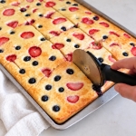 How to make sheet pan pancakes. Bake pancake mix batter in the oven on a greased sheet pan, brush with melted butter, then cut into small portions with a pizza cutter for an easy kid-friendly breakfast that's fast to make.