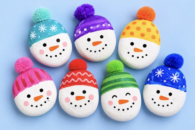 How to make cute snowmen with fuzzy hats using rocks, paint, and a colorful pom-pom. This easy Christmas craft is great for kids of all ages, and simple to make at home using cheap supplies.
