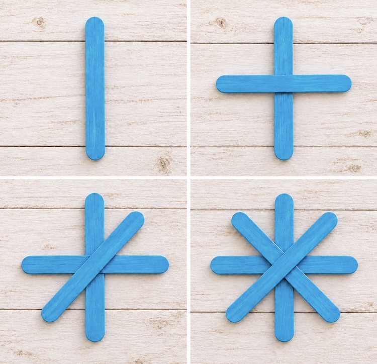 Step by step picture of how to glue together popsicle sticks to make DIY snowflake ornaments for Christmas.