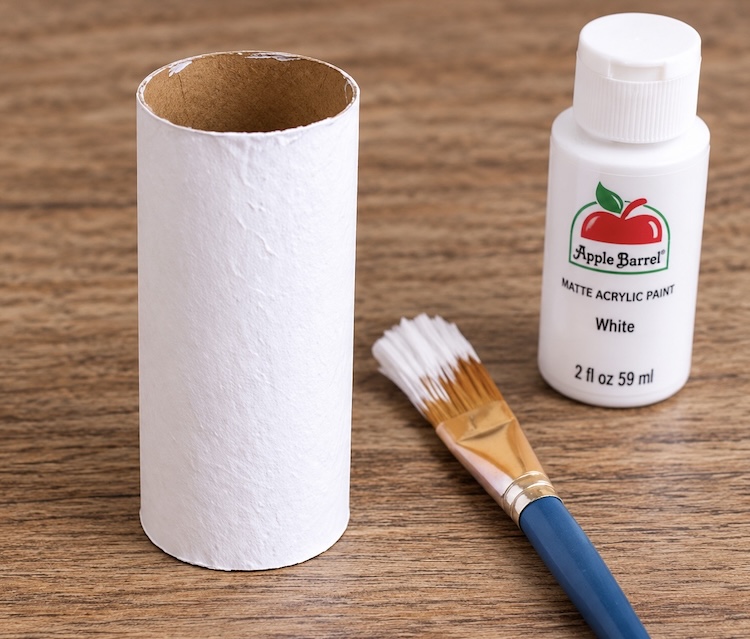 Step one paint a toilet paper roll white with two coats of paint.