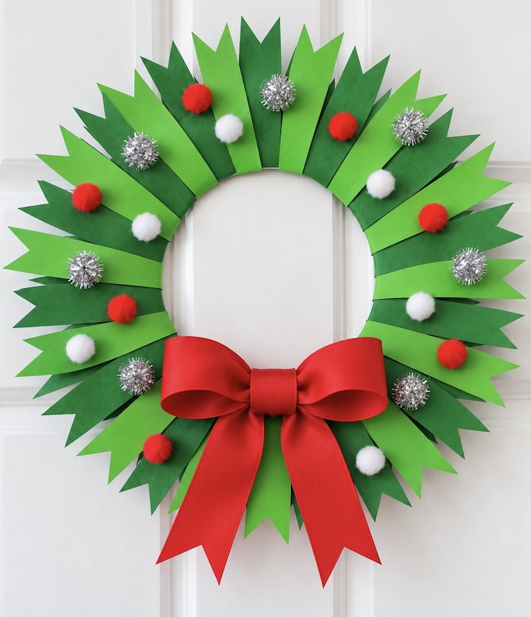 Beautiful DIY Christmas craft idea! How to make a colorful wreath with strips of green paper, a paper plate, and fuzzy pom poms.