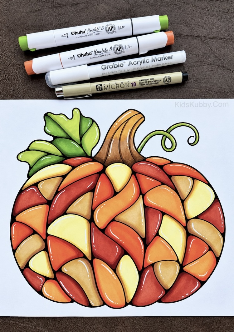 How to color a mosaic pumpkin to look like stained glass with alcohol markers and a white acrylic pen. This fall art project includes a free printable coloring page.