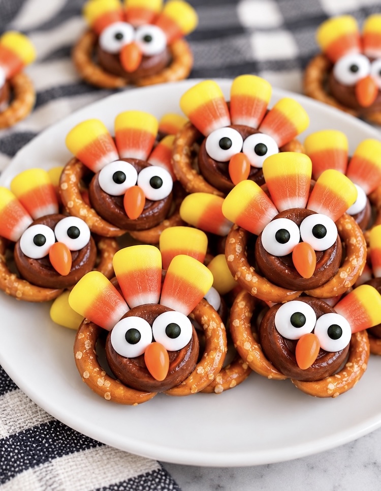 Yummy sweet turkey treats for Thanksgiving! How to make cute holiday chocolate treats with pretzels, Rolos, and candy corn that all come together to look like adorable little turkeys. Use candy eyeballs as the finishing touch. 